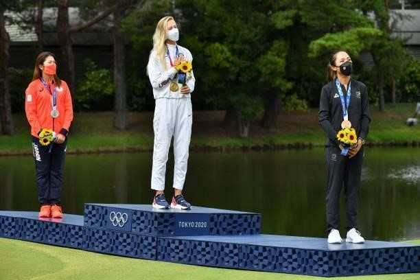 Silver medallist Japan's Mone Inami, gold medallist USA's Nelly Korda and bronze medallist New Zealand's Lydia Ko stand on the podium during the...