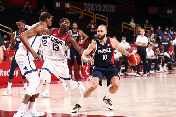 Evan Fournier of the France Men's National Team handles the ball as Bam Adebayo of the USA Men's National Team plays defense during the Gold Medal...