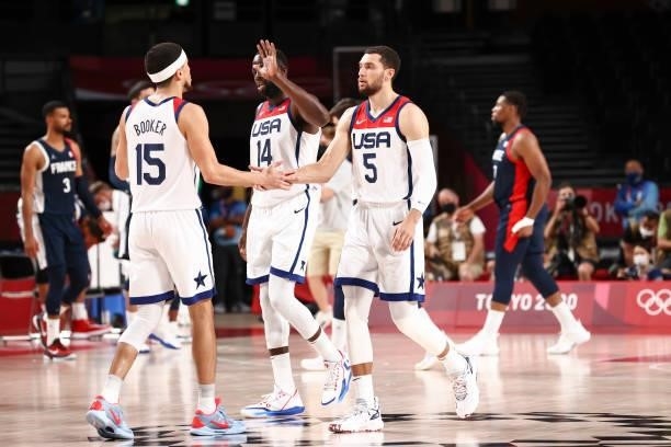 Zach LaVine of the USA Men's National Team high fives Devin Booker of the USA Men's National Team during the Gold Medal Game of the 2020 Tokyo...
