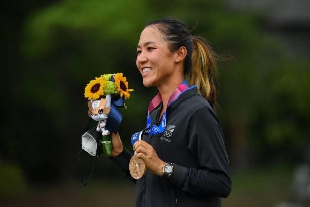 Bronze medallist New Zealand's Lydia Ko holds her medal on the podium during the victory ceremony of the womens golf individual stroke play during...