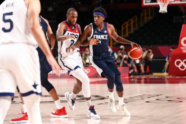 Frank Ntilikina of the France Men's National Team handles the ball as Khris Middleton of the USA Men's National Team plays defense during the Gold...