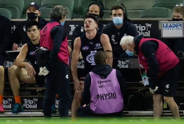 Sam Walsh of the Blues receives medical treatment during the 2021 AFL Round 21 match between the Carlton Blues and the Gold Coast Suns at Marvel...