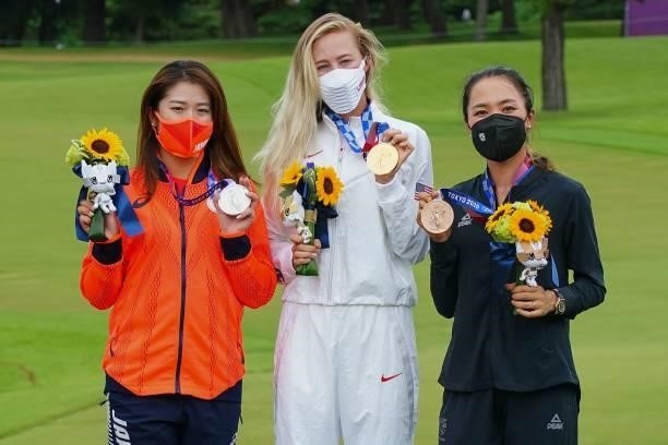 Silver medallist Japan's Mone Inami, gold medallist USA's Nelly Korda and bronze medallist New Zealand's Lydia Ko stand on the podium during the...