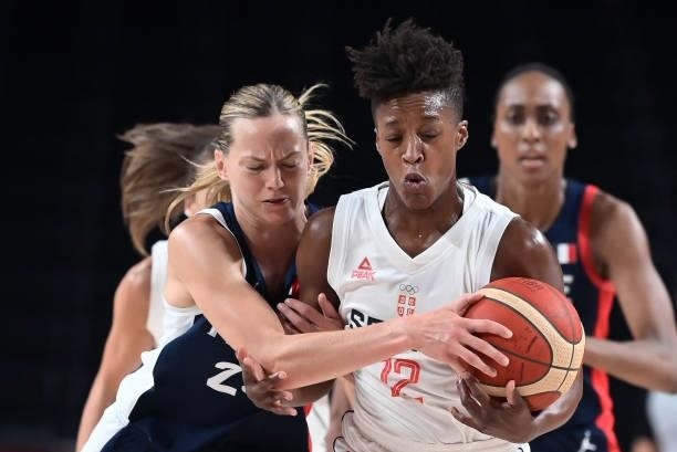 France's Marine Johannes and Serbia's Yvonne Anderson fight for the ball in the women's bronze medal basketball match between Serbia and France...