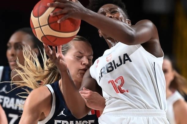 France's Marine Johannes and Serbia's Yvonne Anderson fight for the ball in the women's bronze medal basketball match between Serbia and France...