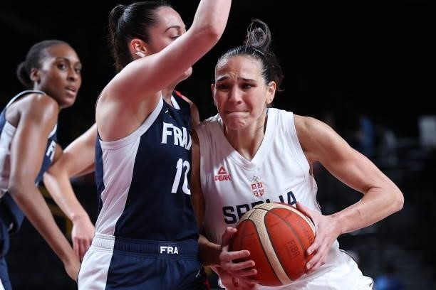 Serbia's Sonja Vasic runs with the ball past France's Sarah Michel in the women's bronze medal basketball match between Serbia and France during the...