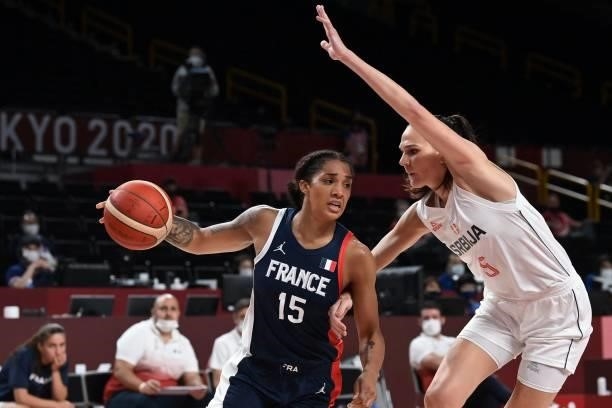 France's Gabrielle Williams dribbles the ball past Serbia's Sonja Vasic in the women's bronze medal basketball match between Serbia and France during...