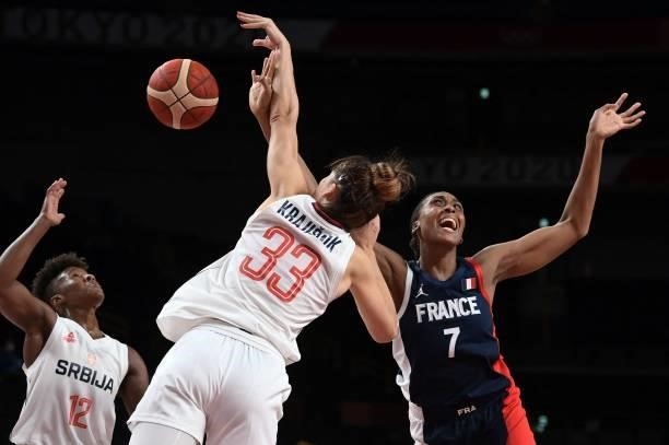 France's Sandrine Gruda and Serbia's Tina Krajisnik fight for the ball in the women's bronze medal basketball match between Serbia and France during...