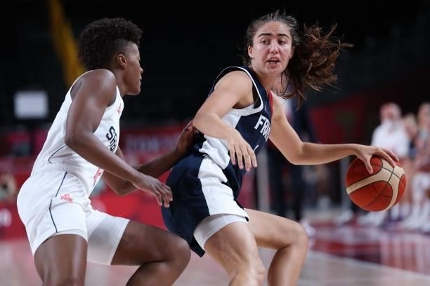 France's Marine Fauthoux dribbles the ball past Serbia's Yvonne Anderson in the women's bronze medal basketball match between Serbia and France...