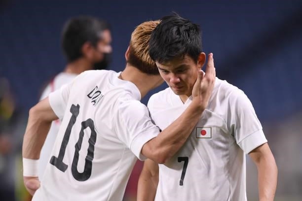 Takefusa Kubo of Japan appears dejected after the loss against Mexico after the 3rd place match while Ritsu Doan of Japan comforts on Day 14 of the...