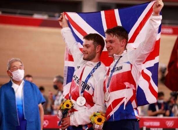 Silver medallists Britain's Ethan Hayter and Britain's Matthew Walls celebrate on podium during the medals ceremony for the men's track cycling...