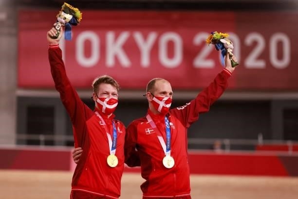 Gold medallists Denmark's Lasse Norman Hansen and Denmark's Michael Morkov celebrate on podium during the medals ceremony for the men's track cycling...