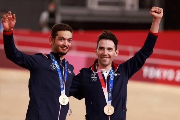 Bronze medallists France's Benjamin Thomas and France's Donavan Grondin celebrate on podium during the medals ceremony for the men's track cycling...