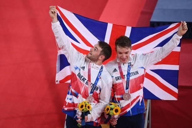 Silver medallists Britain's Ethan Hayter and Britain's Matthew Walls celebrate on podium during the medals ceremony for the men's track cycling...