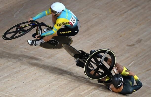 Kazakhstan's Sergey Ponomaryov crashes with Malaysia's Muhammad Shah Firdaus Sahrom in the men's track cycling keirin first round heats during the...
