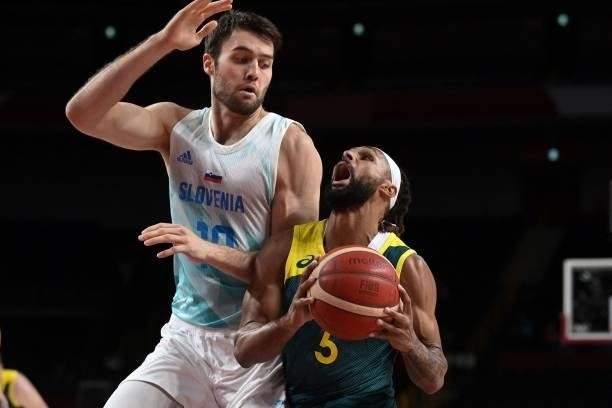 Australia's Patty Mills goes to the basket past Slovenia's Mike Tobey in the men's bronze medal basketball match between Slovenia and Australia...