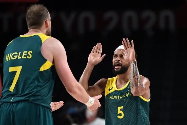 Australia's Patty Mills and Australia's Joe Ingles celebrate after scoring a basket in the men's bronze medal basketball match between Slovenia and...