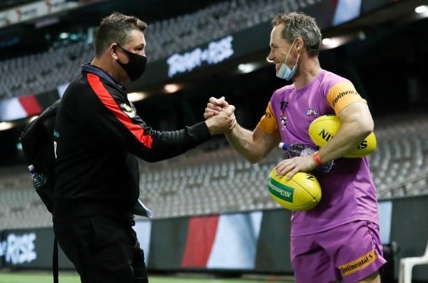 Brett Ratten, Senior Coach of the Saints and runner Tony Brown celebrate during the 2021 AFL Round 21 match between the St Kilda Saints and the...