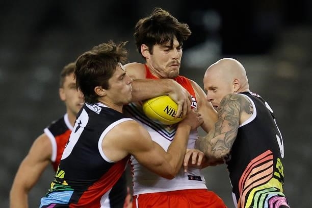 George Hewett of the Swans is tackled by Jack Steele and Zak Jones of the Saints during the 2021 AFL Round 21 match between the St Kilda Saints and...