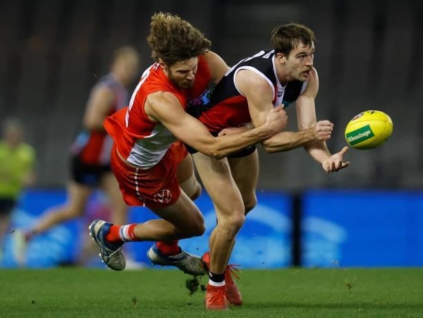 Daniel McKenzie of the Saints is tackled by Tom Hickey of the Swans during the 2021 AFL Round 21 match between the St Kilda Saints and the Sydney...