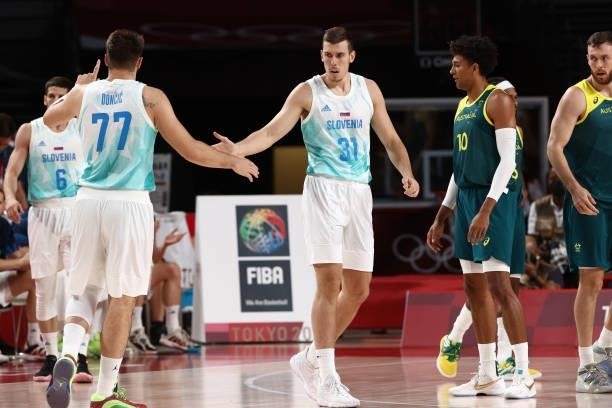 Luka Doncic high fives teammate Vlatko Cancar of the Slovenia Men's National Team during the game against the Australia Men's National Team during...