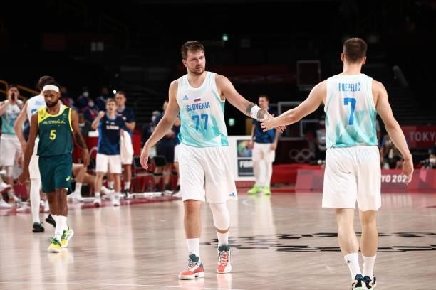 Luka Doncic high fives teammate Klemen Prepelic of the Slovenia Men's National Team during the game against the Australia Men's National Team during...