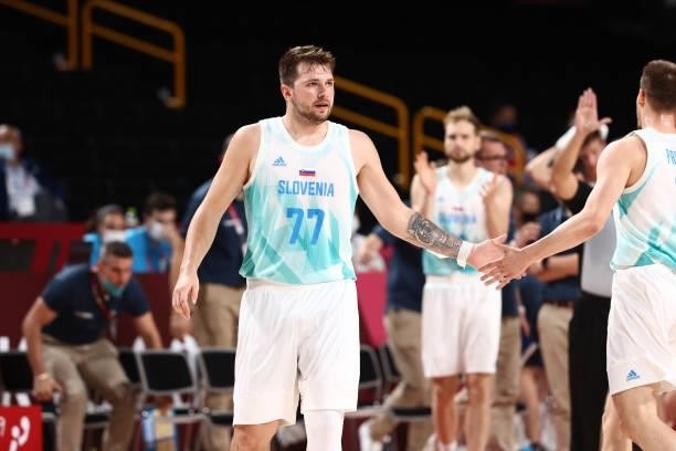 Luka Doncic of the Slovenia Men's National Team high fives teammate during the game against the Australia Men's National Team during the Bronze Medal...