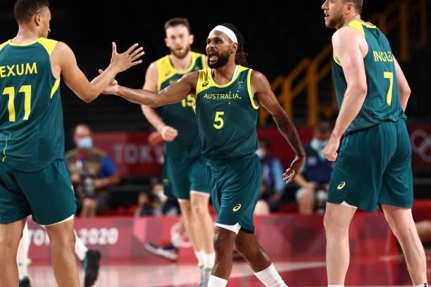 Patty Mills of the Australia Men's National Team high fives teammate Dante Exum during the game against the Slovenia Men's National Team during the...