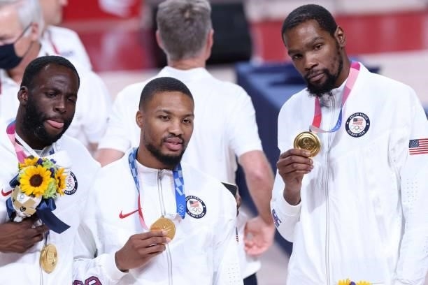 First placed USA's players pose for pictures with their gold medals on the podium during the medal ceremony for the men's basketball competition of...