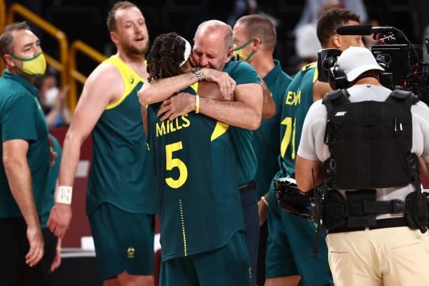 Patty Mills of the Australia Men's National Team and Head Coach Brian Goorjian of the Australia Men's National Team celebrate after the game against...