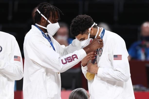 Jerami Grant presents Jayson Tatum of the USA Men's National Team with the gold medal after winning the Gold Medal Game of the 2020 Tokyo Olympics on...