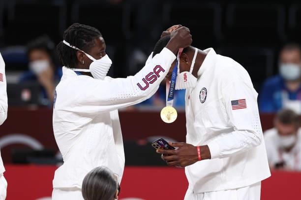 Jrue Holiday presents Bam Adebayo of the USA Men's National Team with the gold medal after winning the Gold Medal Game of the 2020 Tokyo Olympics on...