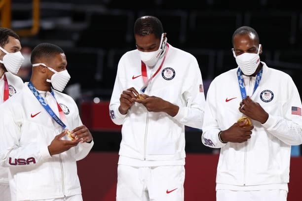 Damian Lillard, Kevin Durant and Khris Middleton of the USA Men's National Team celebrate after winning the Gold Medal Game of the 2020 Tokyo...