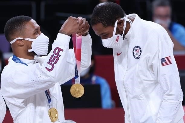 First placed team USA's Damian Lillard puts on the gold medal on his teammate Kevin Wayne Durant on the podium during the medal ceremony for the...