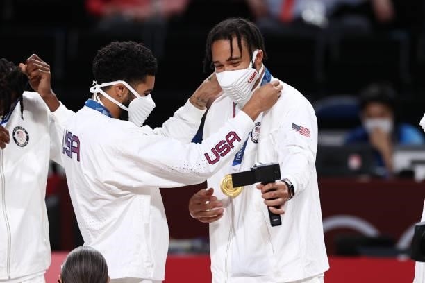 Jayson Tatum presents JaVale McGee of the USA Men's National Team with the gold medal after winning the Gold Medal Game of the 2020 Tokyo Olympics on...