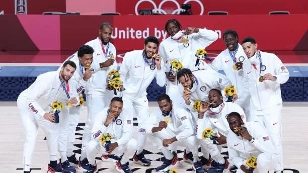 First placed USA's players pose for pictures with their gold medals on the podium during the medal ceremony for the men's basketball competition of...