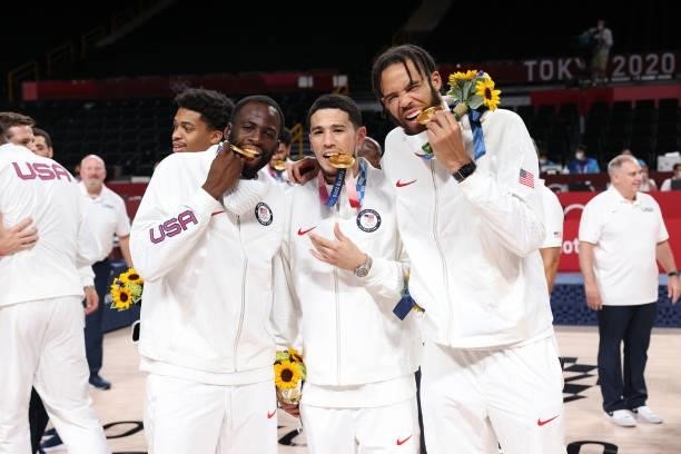 Draymond Green, Devin Booker and JaVale McGee of the USA Men's National Team pose for a picture during the Medal Ceremony of the 2020 Tokyo Olympics...