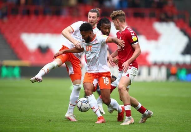 Grant Ward and James Husband of Blackpool tangles with Alex Scott of Bristol City during the Sky Bet Championship match between Bristol City and...