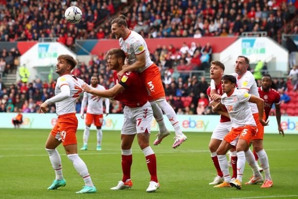 Nathan Baker of Bristol City in action with James Husband of Blackpool during the Sky Bet Championship match between Bristol City and Blackpool at...