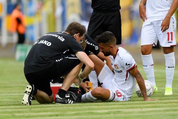 Kerem Demirbay of Bayer 04 Leverkusen receives medical treatment during the DFB Cup first round match between 1. FC Lok Leipzig and Bayer Leverkusen...