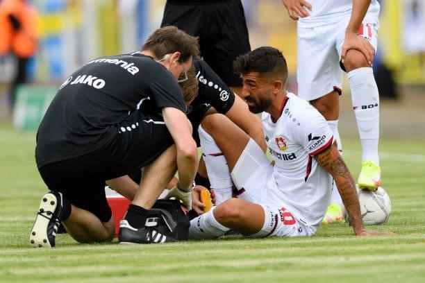 Kerem Demirbay of Bayer 04 Leverkusen receives medical treatment during the DFB Cup first round match between 1. FC Lok Leipzig and Bayer Leverkusen...