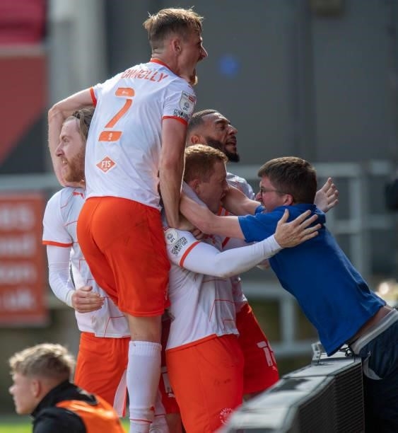 Blackpool celebrates scoring there first goal with a fan during the Sky Bet Championship match between Bristol City and Blackpool at Ashton Gate on...