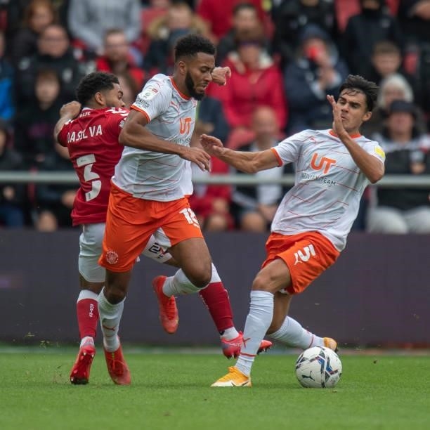 Blackpool's Grant Ward and Reece James battles for possession with Bristol City's Jay Dasilva during the Sky Bet Championship match between Bristol...