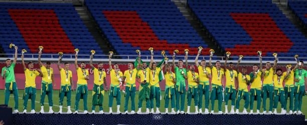 Gold medalists of Team Brazil celebrate on the podium with their gold medals during the Men's Football Competition Medal Ceremony on day fifteen of...
