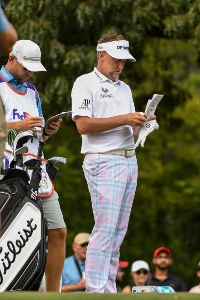 Ian Poulter of England writes in his yardage book at the eighth hole during the third round of the World Golf Championships-FedEx St. Jude...