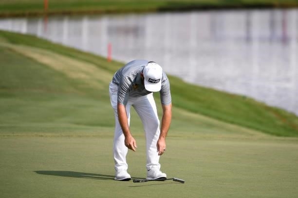 Louis Oosthuizen of South Africa drops his putter after missing his birdie putt at the 18th hole during the third round of the World Golf...