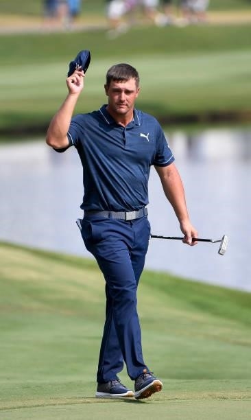 Bryson DeChambeau tips his hat to the crowd at the 18th hole during the third round of the World Golf Championships-FedEx St. Jude Invitational at...