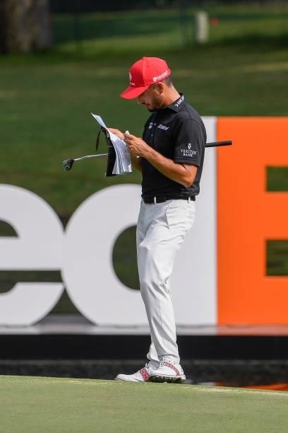 Abraham Ancer of Mexico looks over his yardage book at the 18th green during the third round of the World Golf Championships-FedEx St. Jude...