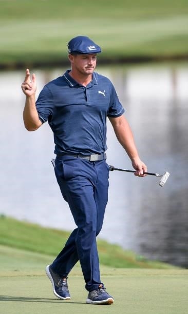 Bryson DeChambeau waves to the crowd at the 18th hole during the third round of the World Golf Championships-FedEx St. Jude Invitational at TPC...