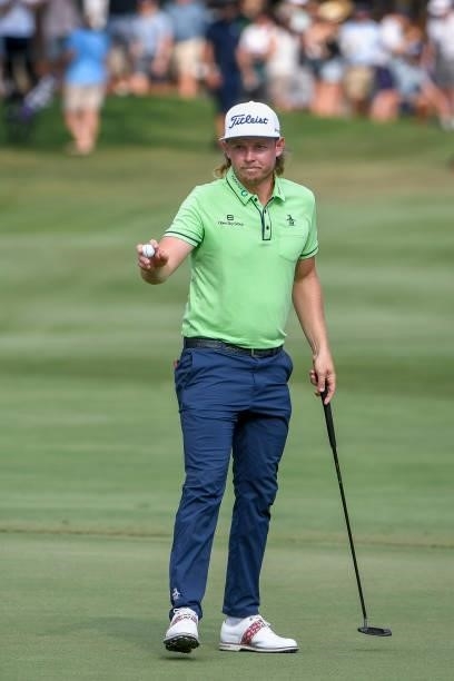 Cameron Smith of Australia with putter waves his ball to the fans at the 18th hole during the third round of the World Golf Championships-FedEx St....